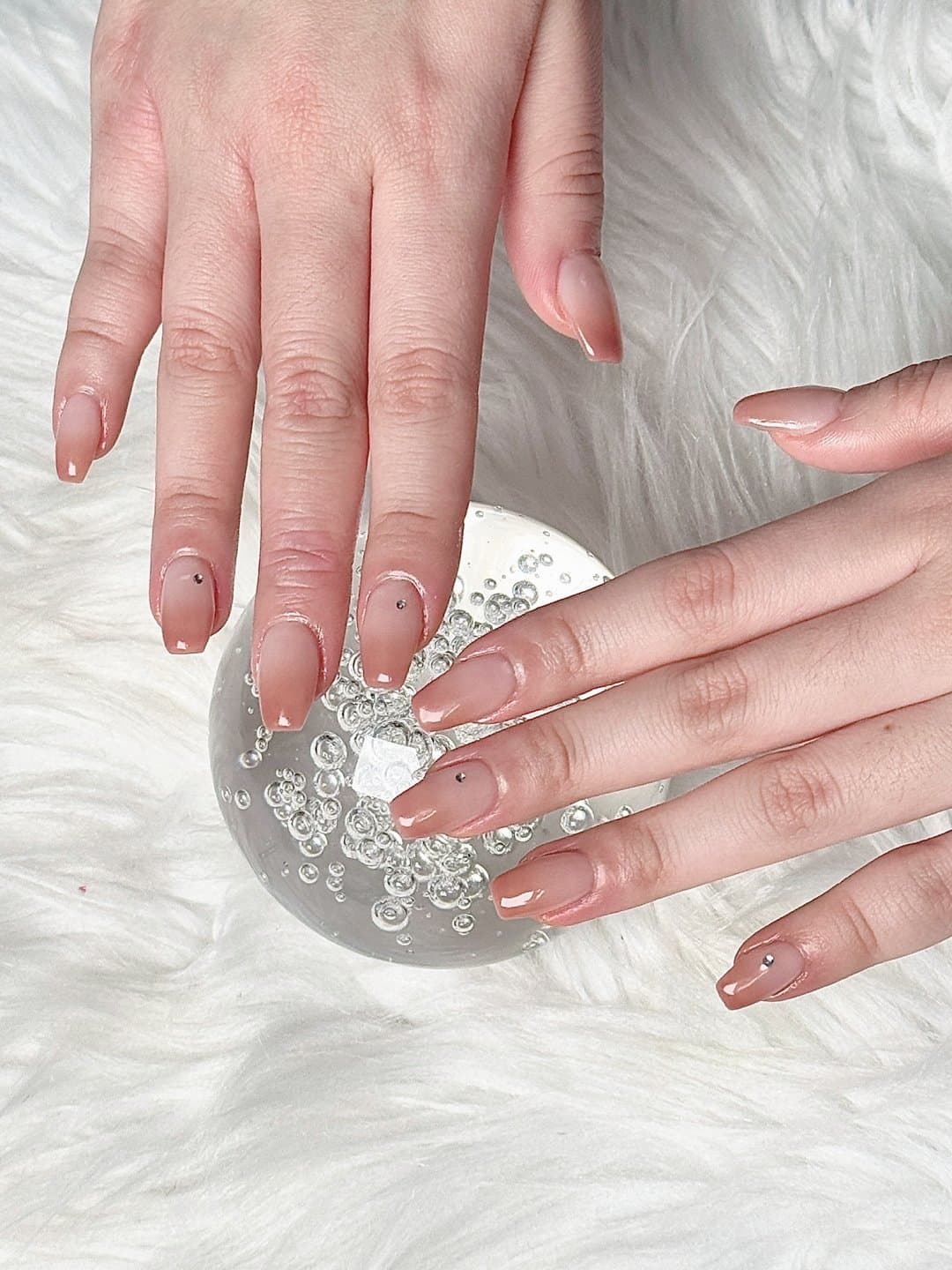 Soft nude pink gel nails with tiny gem detail